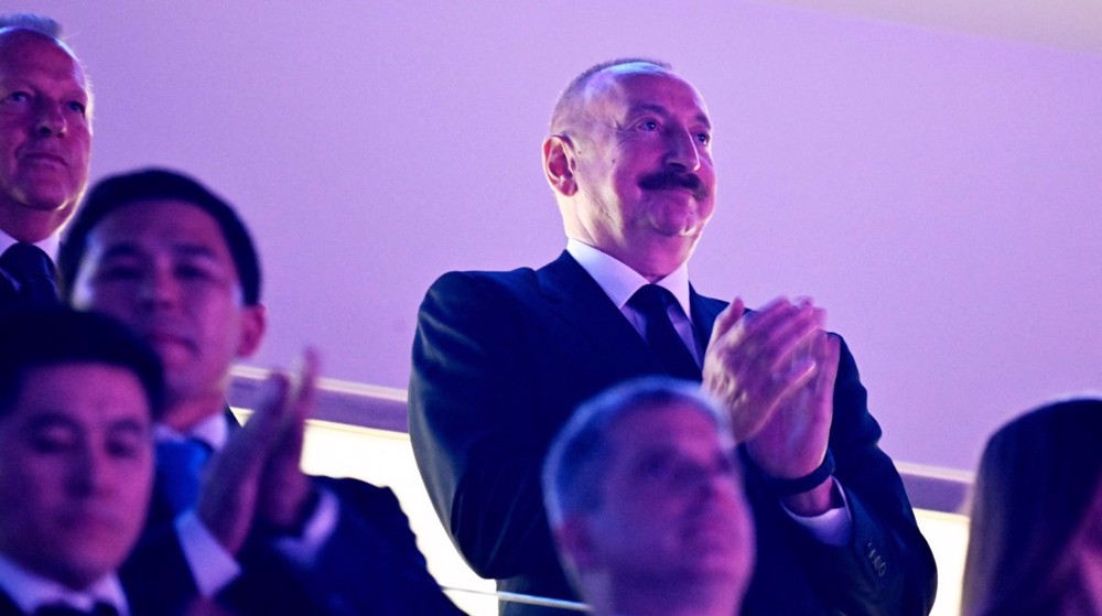 Azerbaijan's President Ilham Aliyev (R) applauds during the opening ceremony of the World Judo Champ