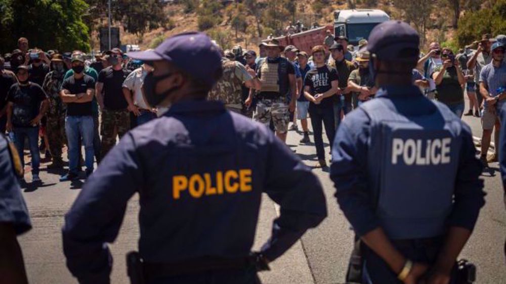 South African white farmers, black protesters face off over farm murder