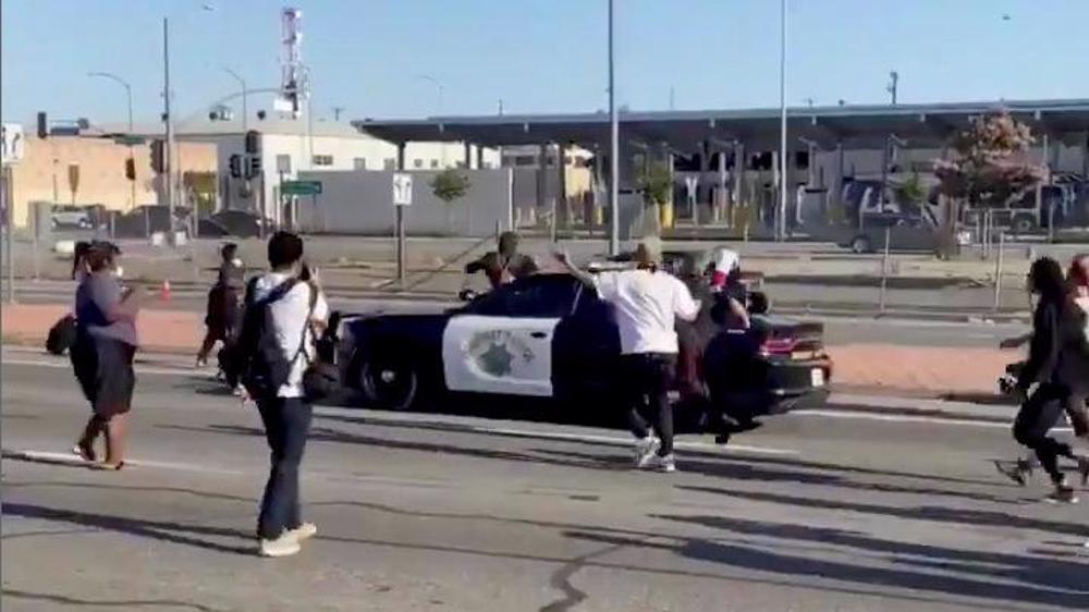 Protester falls off police car during protest over Floyd’s death