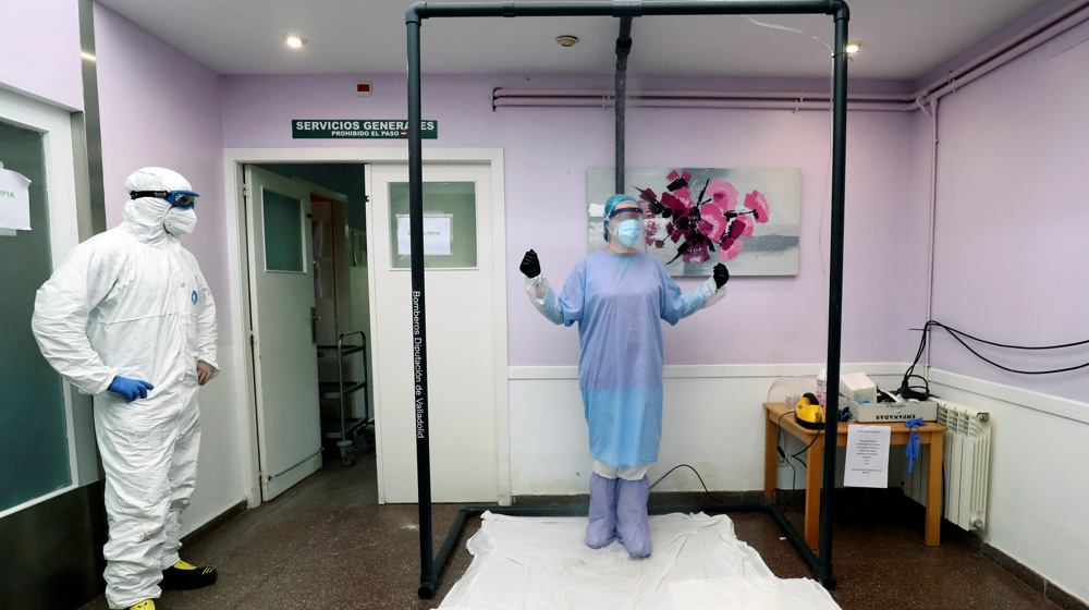 Spanish firefighters build disinfection shower to curb coronavirus