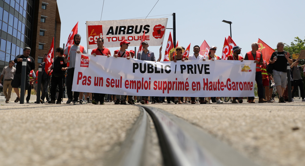Airbus workers, subcontractors march to Toulouse airport for layoffs protest