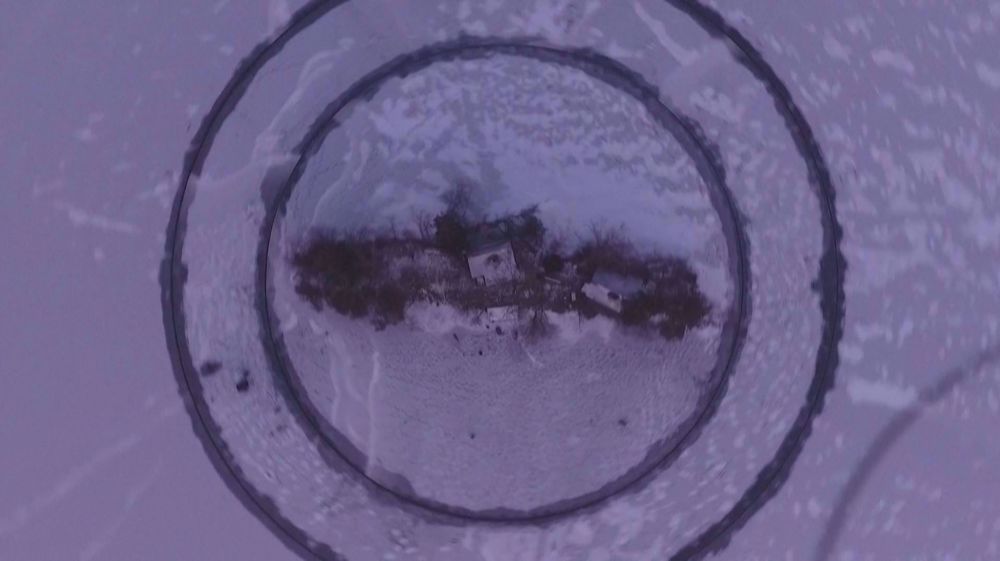 Finnish inventor builds rotating ice donut with sauna on lake