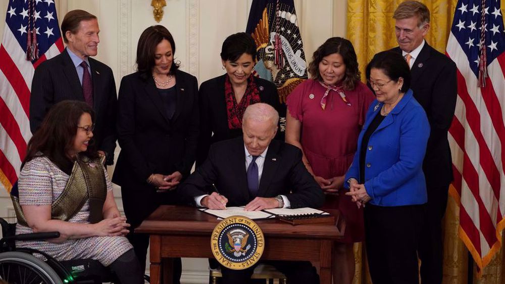 Biden signs bill to counter spike in anti-Asian hate crime