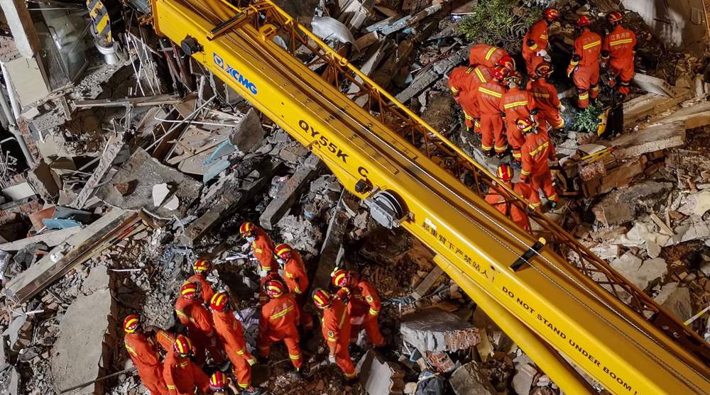 Firefighters rescue trapped survivors after deadly Chinese hotel collapse