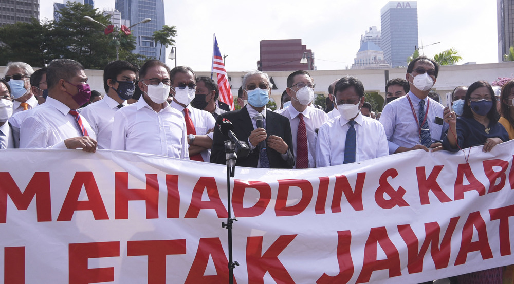Malaysia opposition lawmakers march on parliament, demand PM resign 