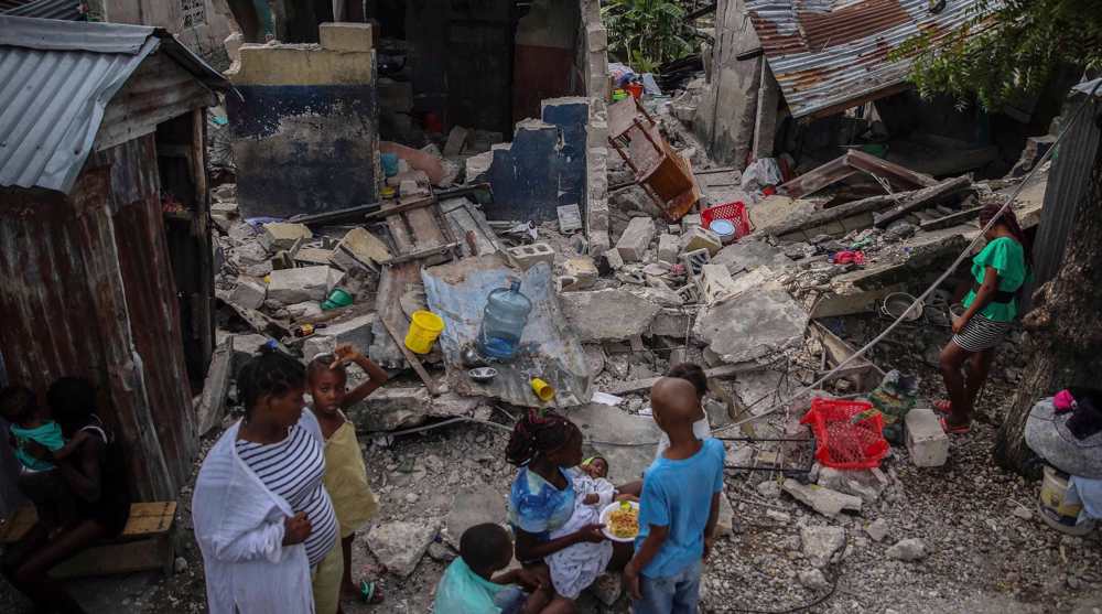 Haitians loot aid trucks a week after quake killed over 2,000