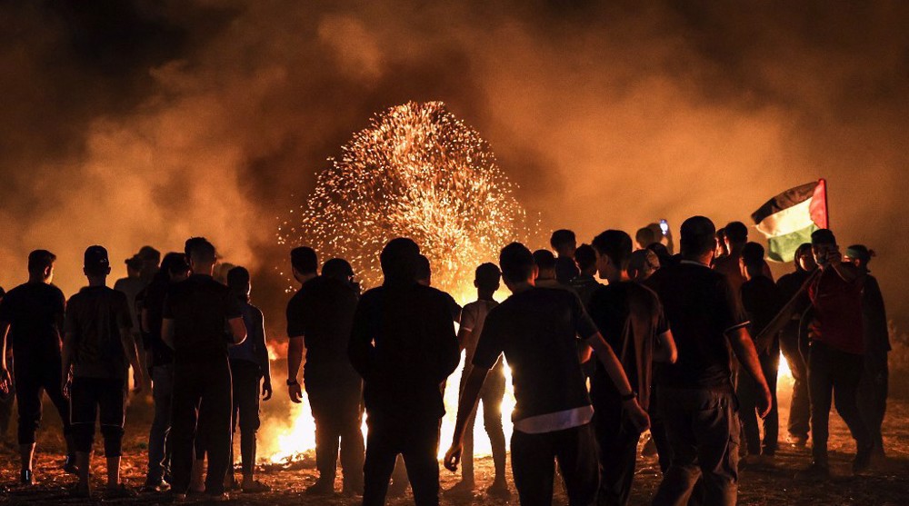 Gazans burn tires near fence for 2nd night to protest Israeli siege 