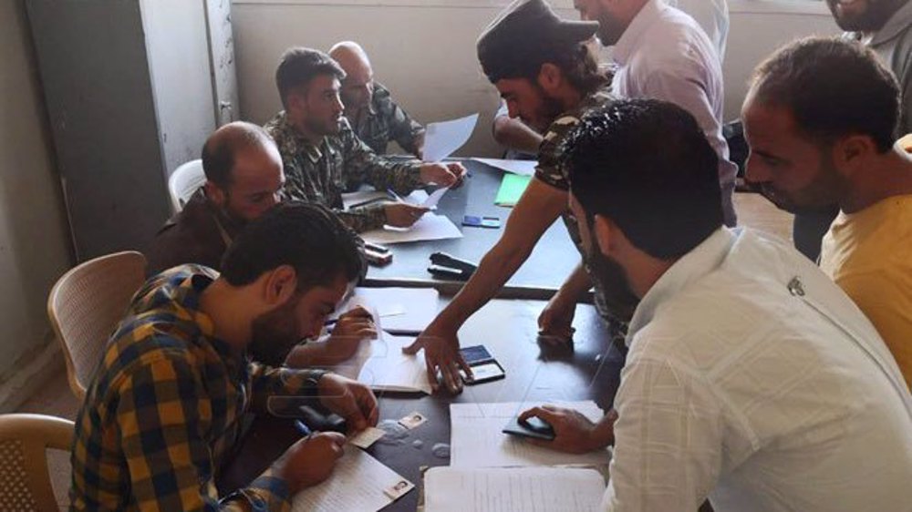 Hundreds of armed militants lay down weapons in Syria’s Tafas