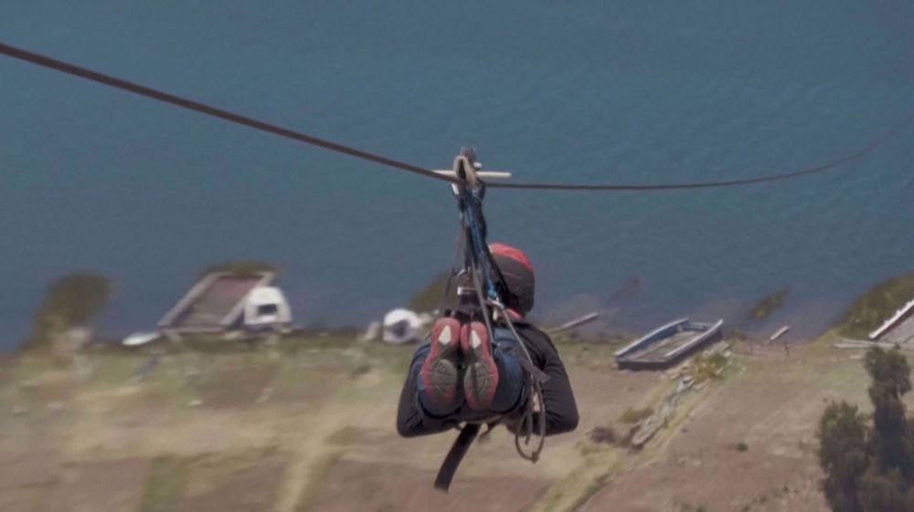 Adrenaline junkies cross Titicaca lake on a zip line in Bolivia