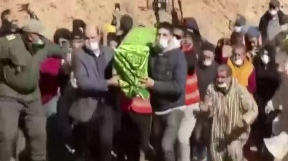 Mourners carry coffin of Moroccan child Rayan as it arrives for burial