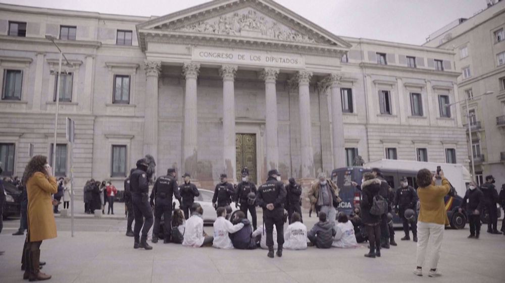 Climate activists paint Spain's parliament the color of blood