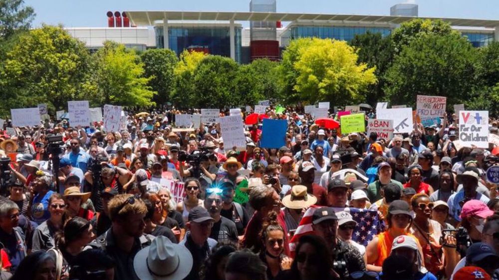 Americans protest gun violence after carnage; leaders say more firearms needed