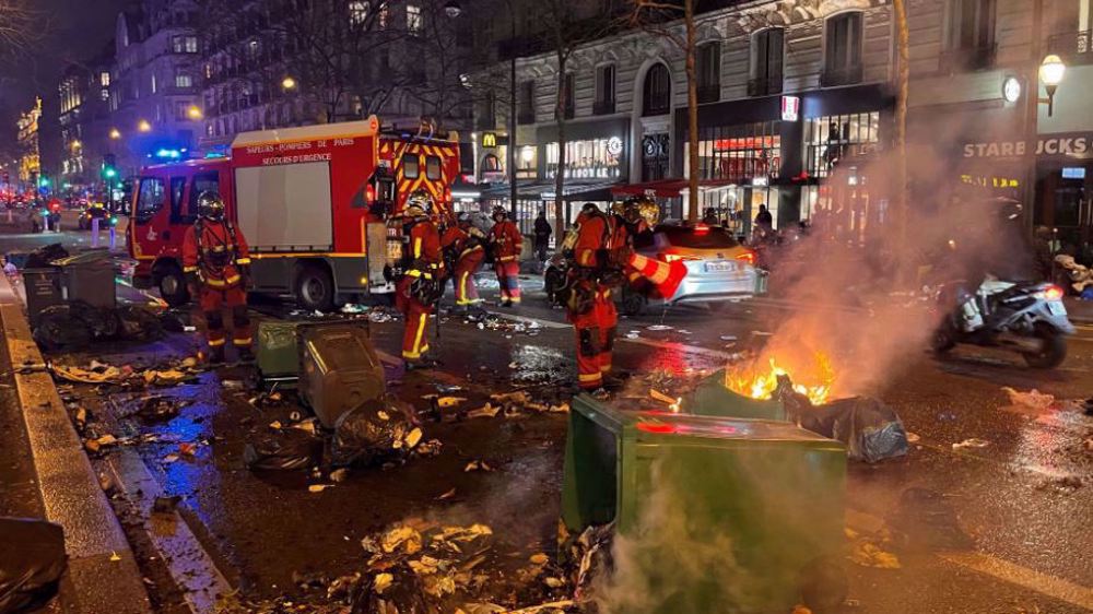 French police fire tear gas as protesters set rubbish on fire 