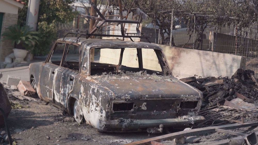 Fire destroys cars, houses near Athens as Greece battles blazes