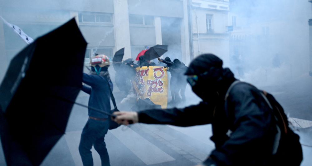Final result still uncertain as far right leads France election, exit polls show
