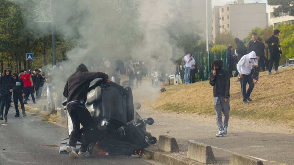 Over 400 detained in student protests across France as public workers join strike