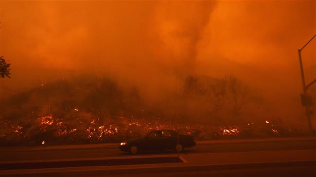 Calif. wildfire said set by arsonist threatens community