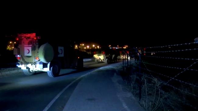 A large convoy of Turkey-backed rebels arrives at Syrian border