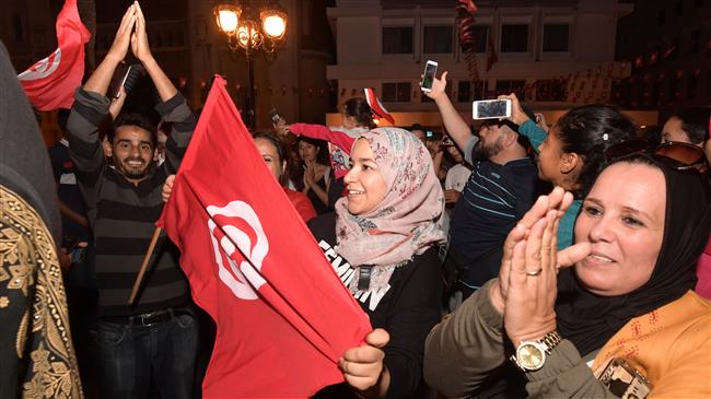 Tunisians celebrate Kais Saied's landslide projected win