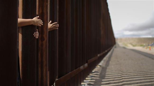 Trump praises border wall before banning immigration