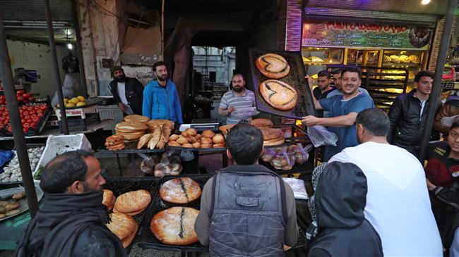 Syrians flood markets to buy traditional Ramadan sweets in Idlib
