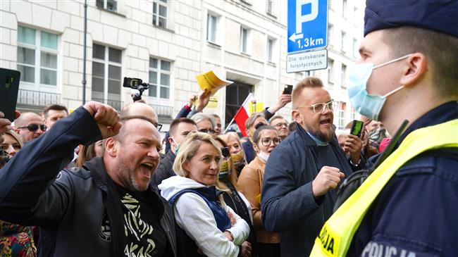 Poles stage car-honking COVID-19 protest in Warsaw 