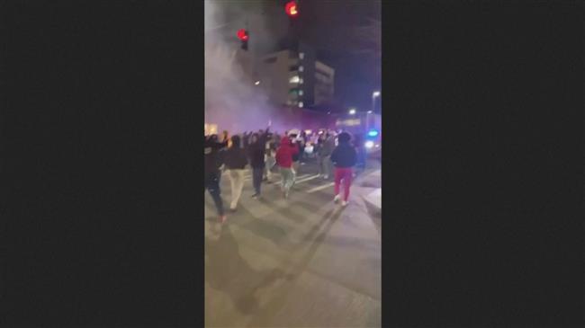 US police vehicle plows through crowd watching street race