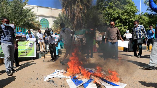 Sudan protesters burn Israeli flag in rally against normalization deal