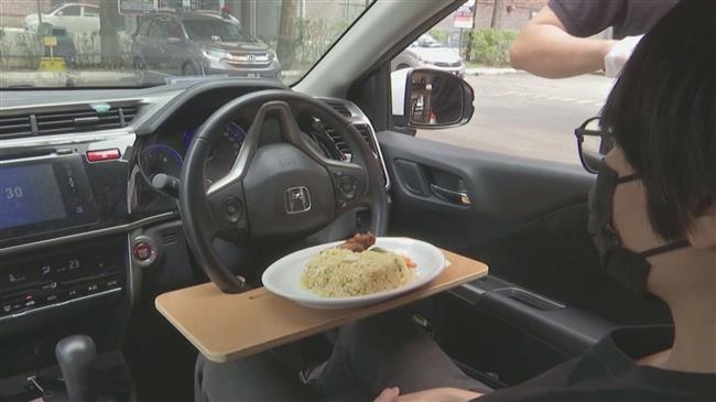 Malaysian restaurant shifts gears to drive-in service amid virus measures  